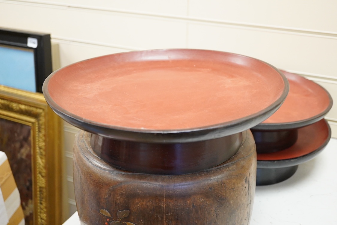 A Japanese lacquered paulownia wood hibachi, 20.5cm high and three Burmese lacquer stands